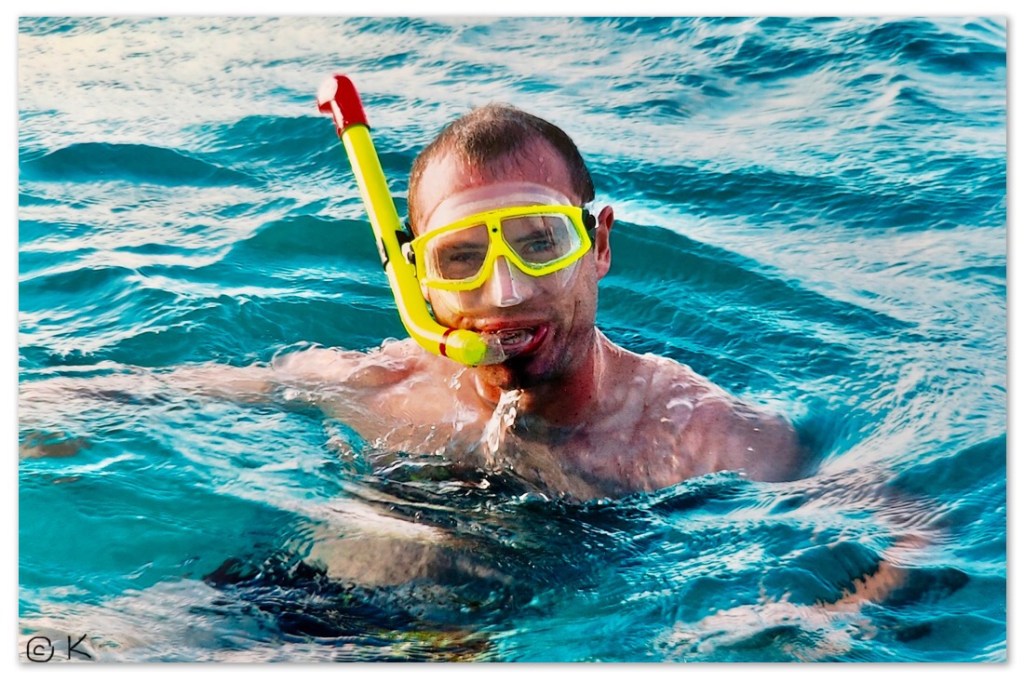 Man in water with a snorkel /Swimming with sharks and a stingray that purrs @ Kirsten K Kester | InsightandVisions.com